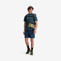 Model shot of Topo Designs X Tenkara Rod Co Kit Accessory Shoulder Bag in "Sierra".