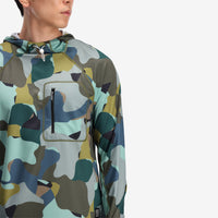 General on model close in photo of the front pocket for the Topo Designs Men's River Hoodie 30+ UPF moisture wicking quick dry top in "Green Camo" green.