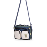 Front quarter view of Topo Designs Block Bag in "Forest / Bone White"