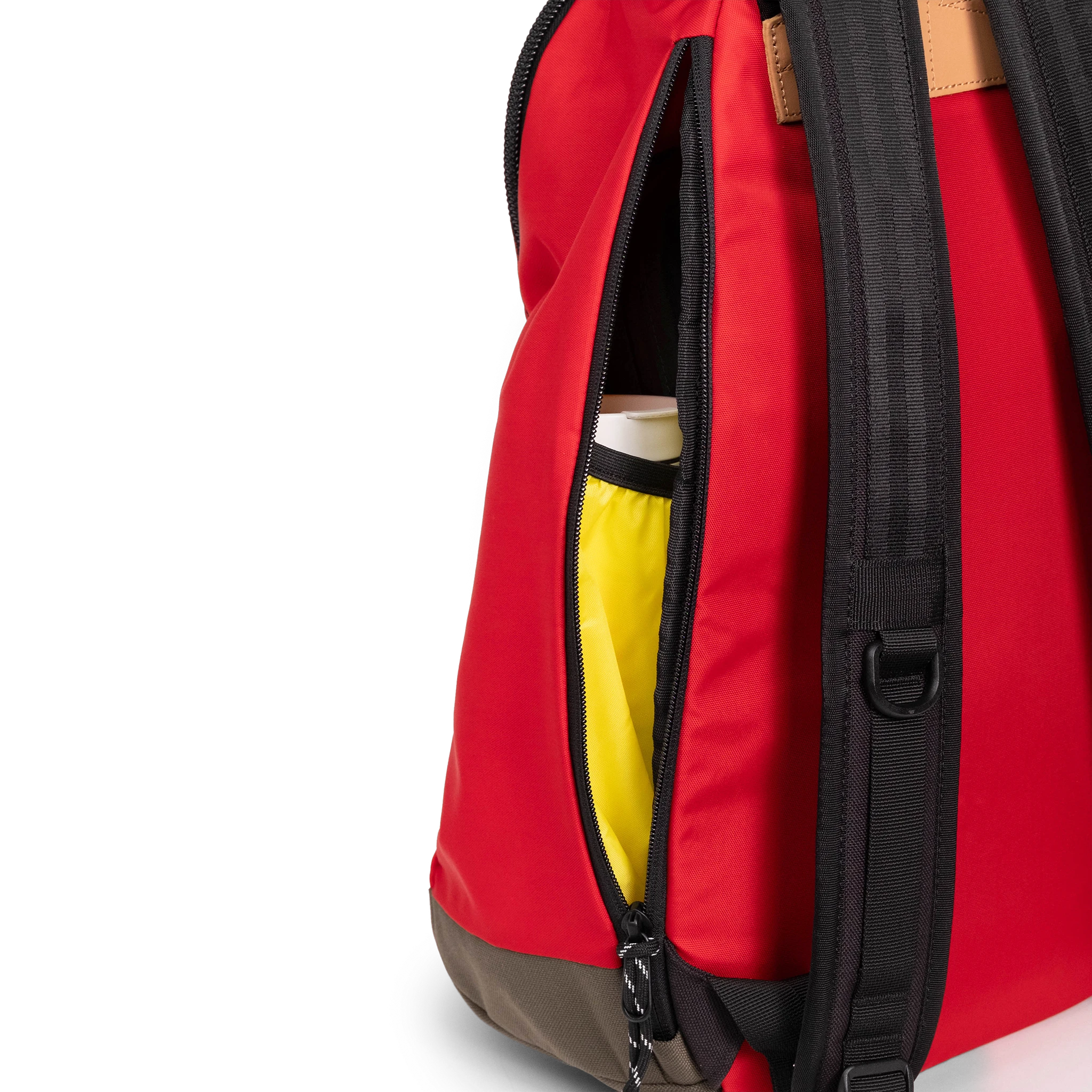 General detail view of Topo Designs Classic Teardrop Backpack in "Salsa" with the side zippered access opened.
