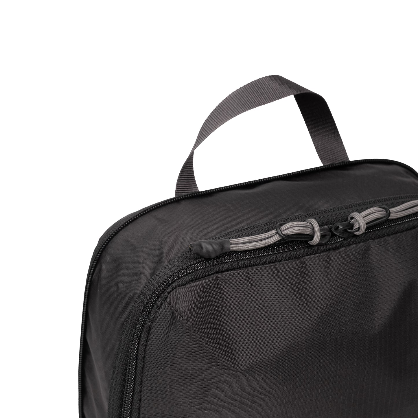 Top zipper detail white background image of Topo Designs Global Compression Pack Bag Set in "Black / Black"