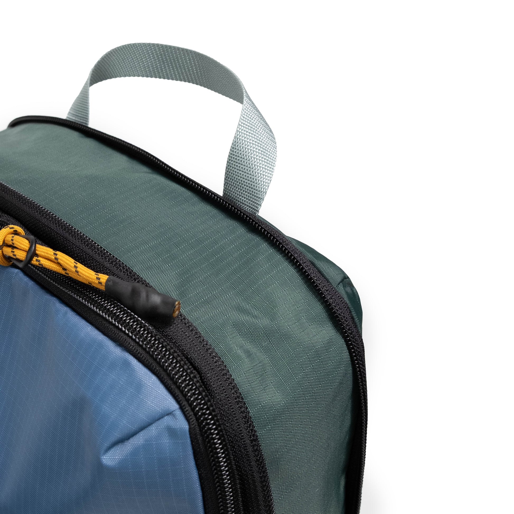Front zipper detail white background image of Topo Designs Global Compression Pack Bag Set in "Stone Blue / Forest"