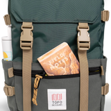 General shot Topo Designs Rover Pack Classic laptop backpack in "Forest" showing front zippered pouch and notebook.