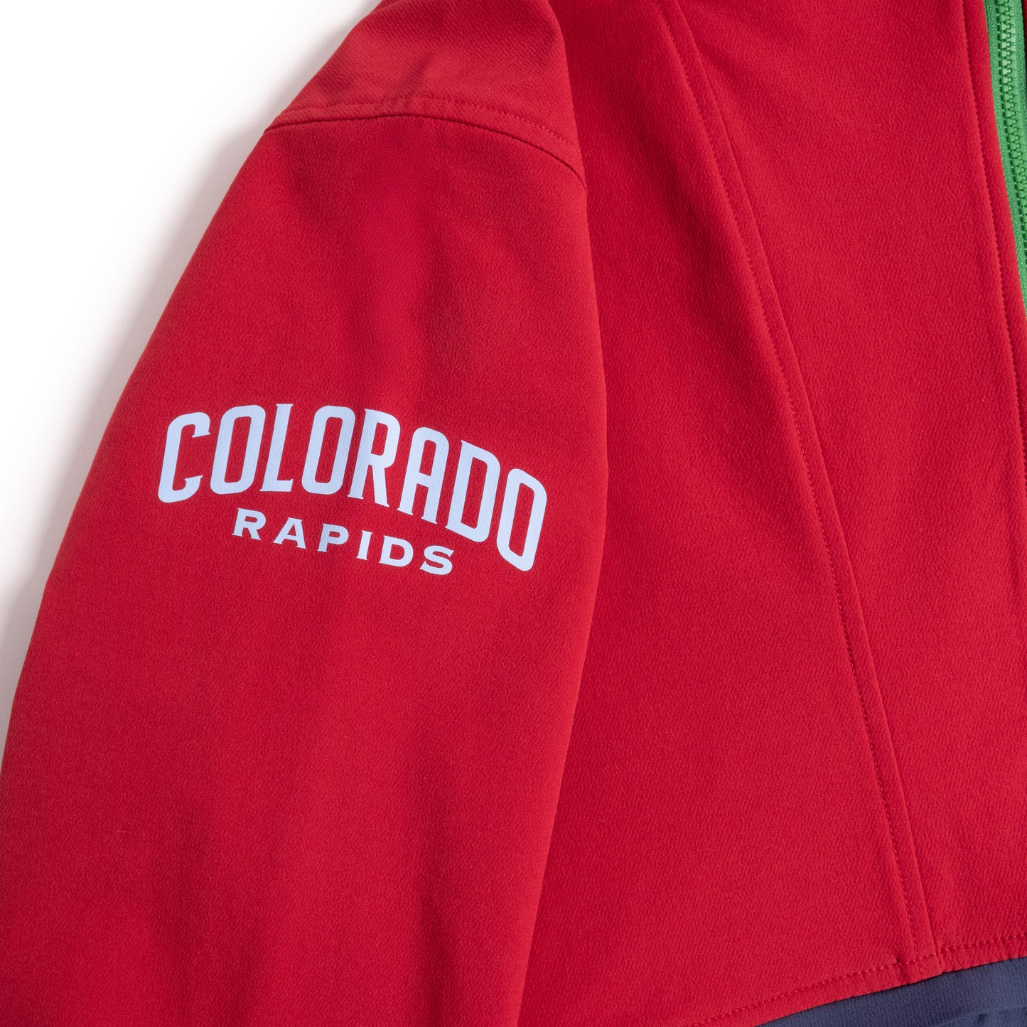 Sleeve detail view of Topo Designs x Colorado Rapids HighPeak Jacket in "Rio Red / Midnight"