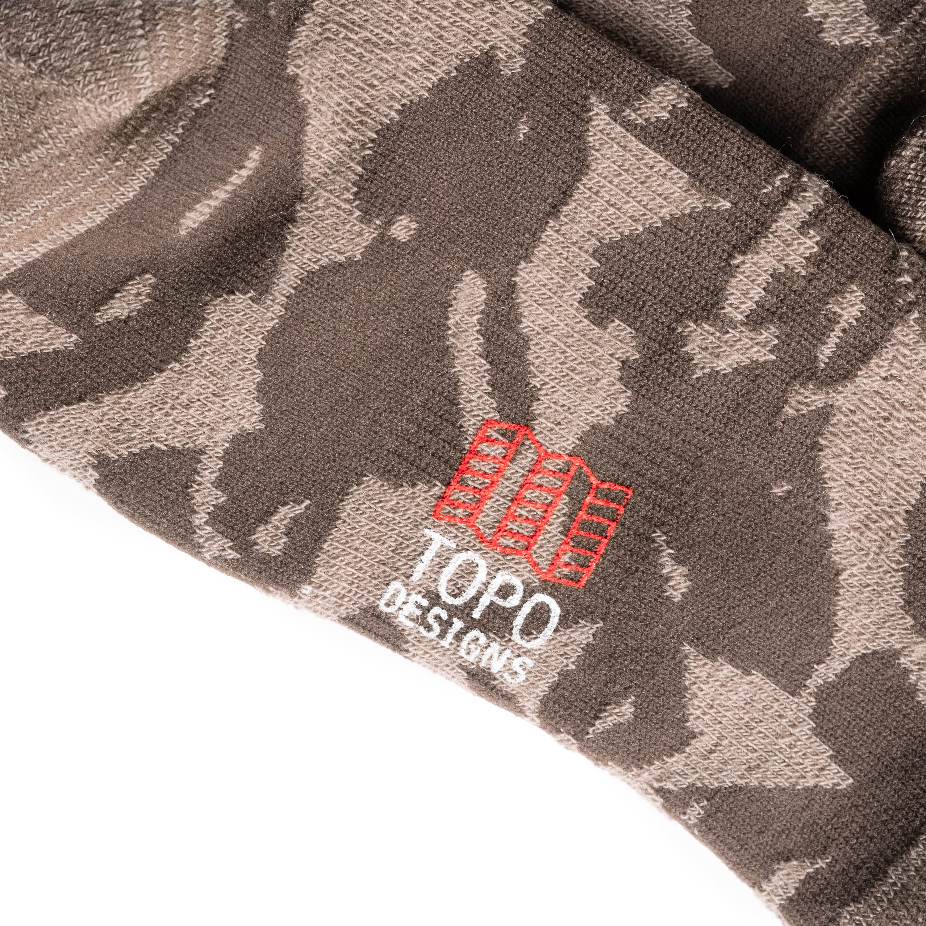 Logo detail shot of Topo Designs Town Socks in "Cobblestone Geo"
