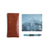 General view of VALLON X Topo Designs sunglasses accessories in "Brown / Brown" with microfiber cloth, leather sunglasses case, and sunglasses strap.