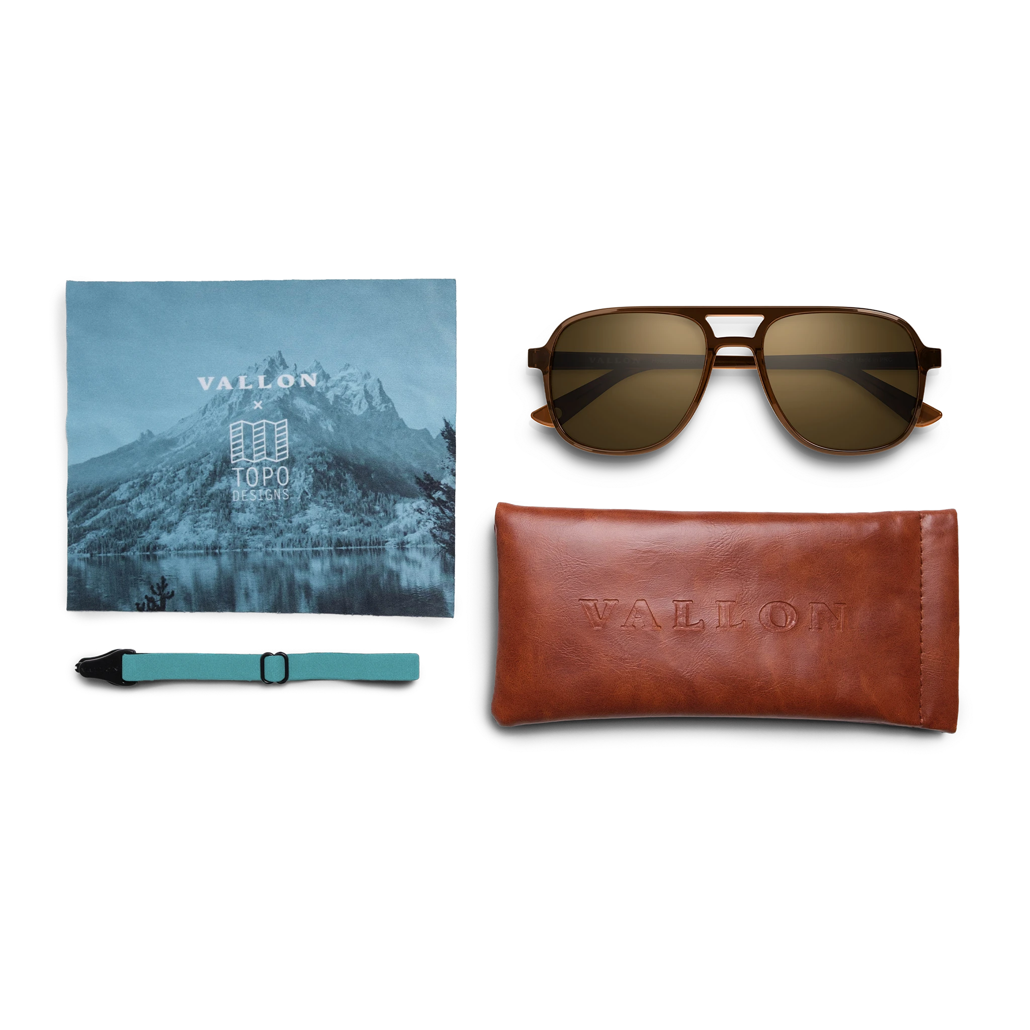 General view of VALLON X Topo Designs sunglasses in "Brown / Brown" with microfiber cloth, leather sunglasses case, and sunglasses strap.