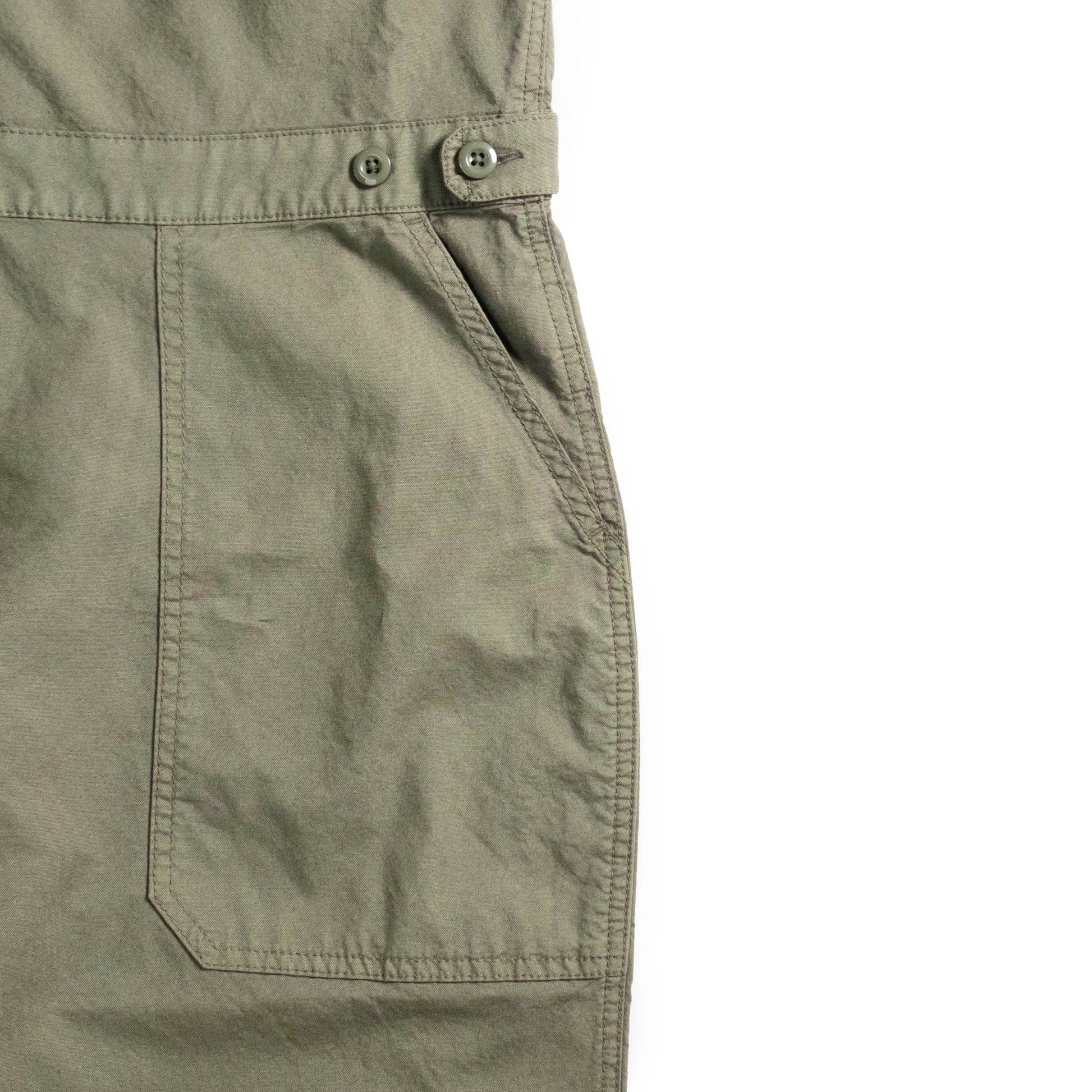 Front pocket detail white background flat lay image of Topo Designs Desert Coverall - Women's in "Beetle"