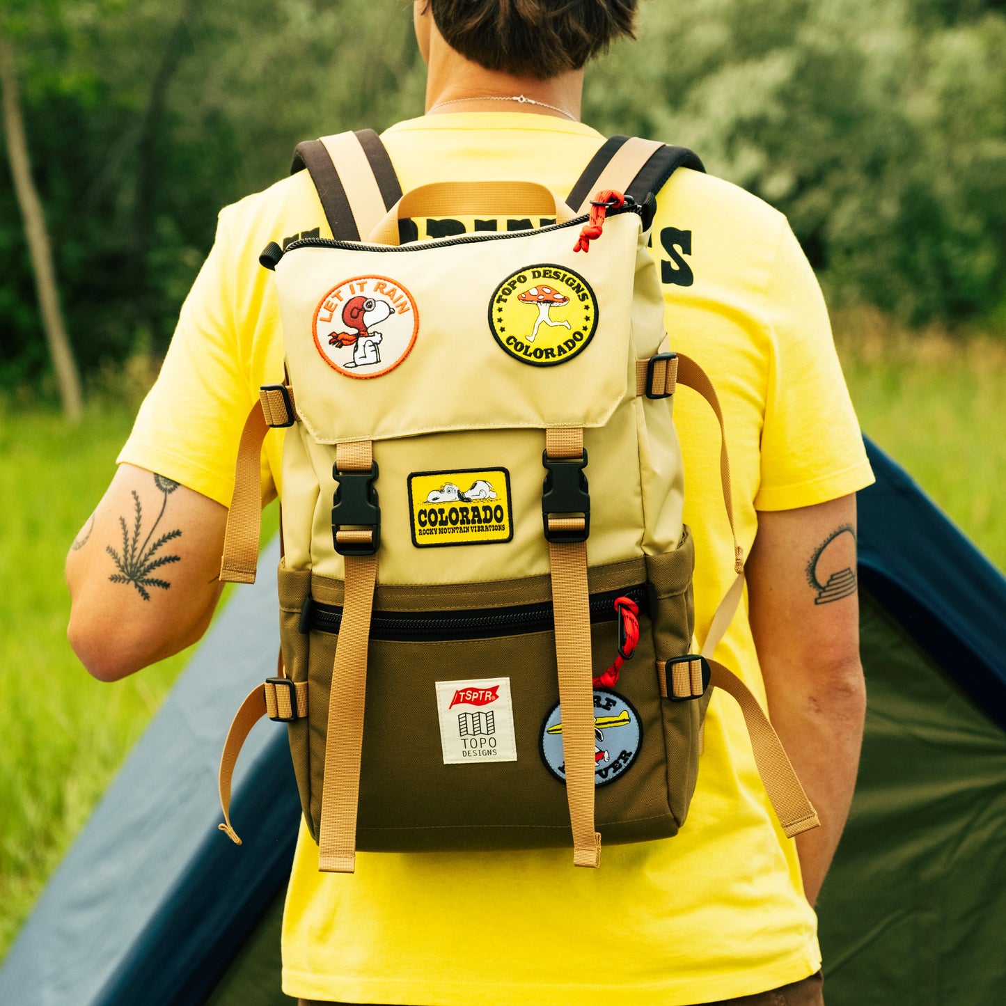 Model lifestyle photo of Rover Pack Classicof man at camp site wearing backpack.