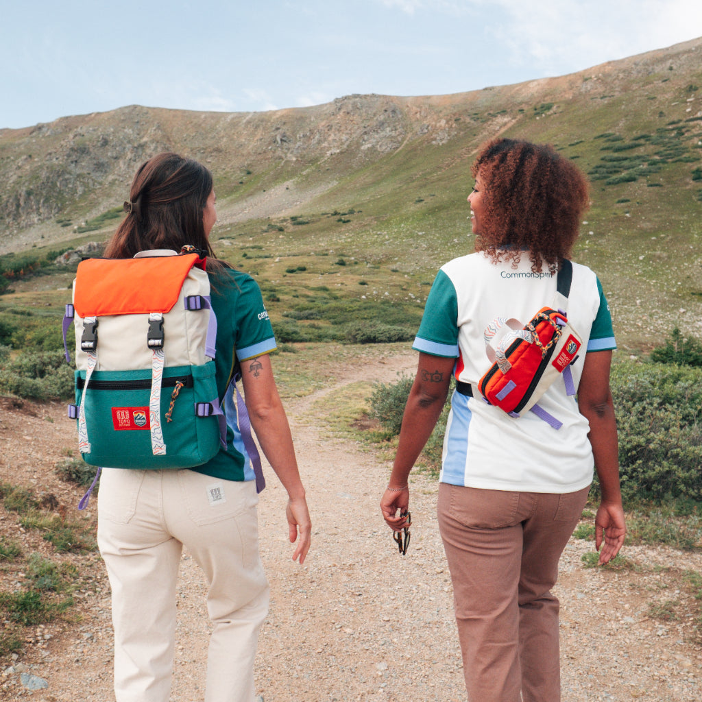 Front lifestyle quarter shot of Topo Designs x Denver Summit Mini Quick Pack in "Sandstone / Bone White" and Rover Pack Classic.