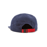 Back of Topo Designs Nylon Camp 5-panel flat brim Hat in "Navy" blue showing adjustable webbing clip strap.