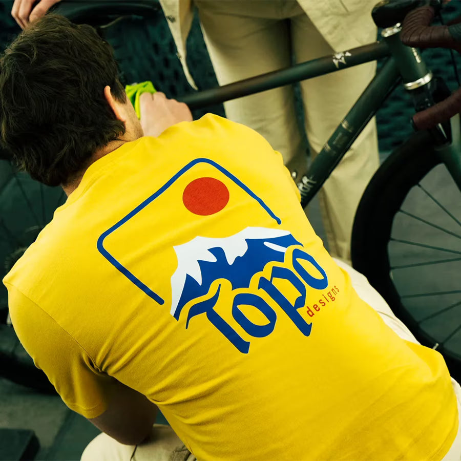 Lifestyle image of Topo Designs Peak Tee - Men's in "Goldenrod"