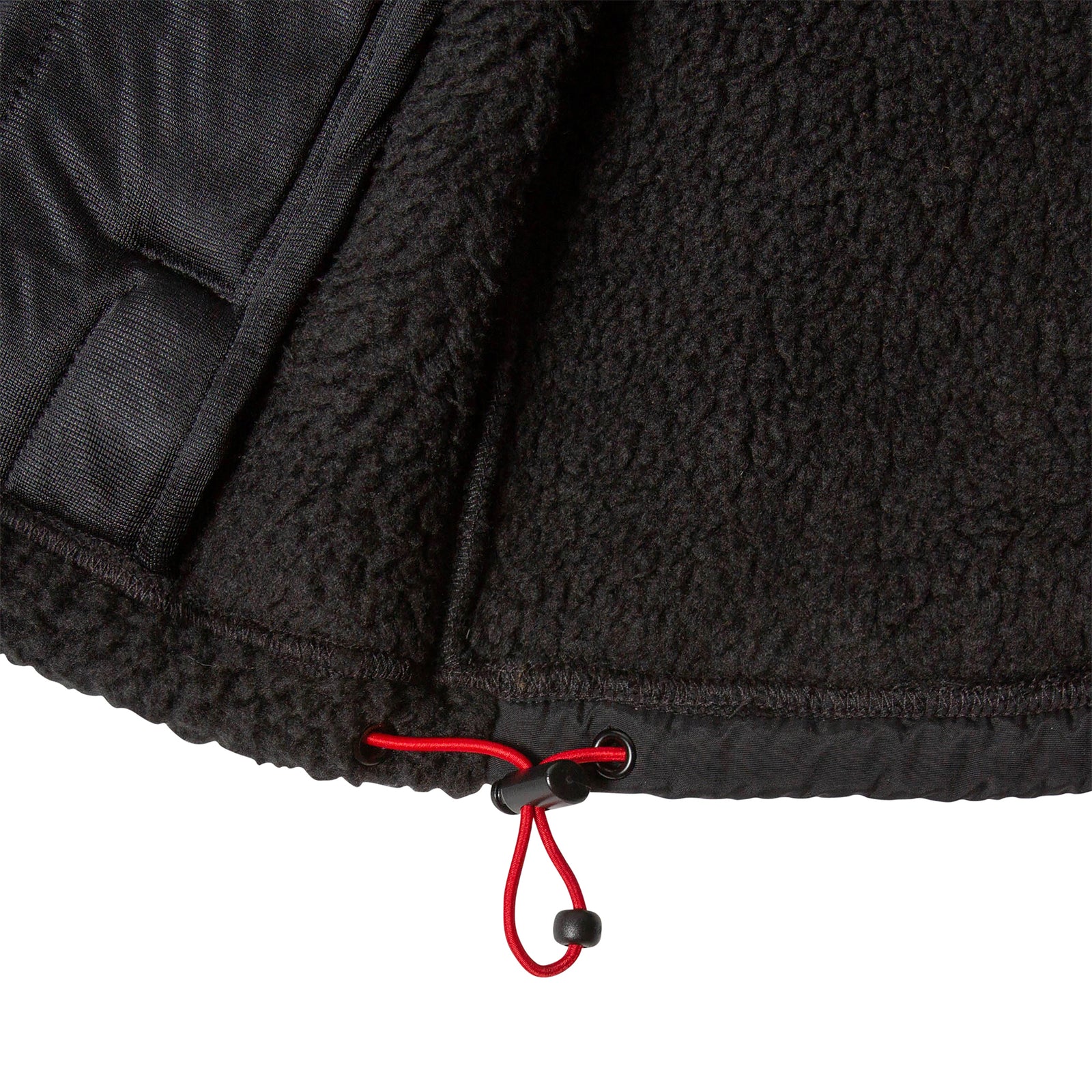 General detail product shot of the women's subalpine fleece in black showing shock cord hem adjustment.