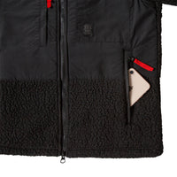 General detail product shot of the women's subalpine fleece in black showing open zip pocket.