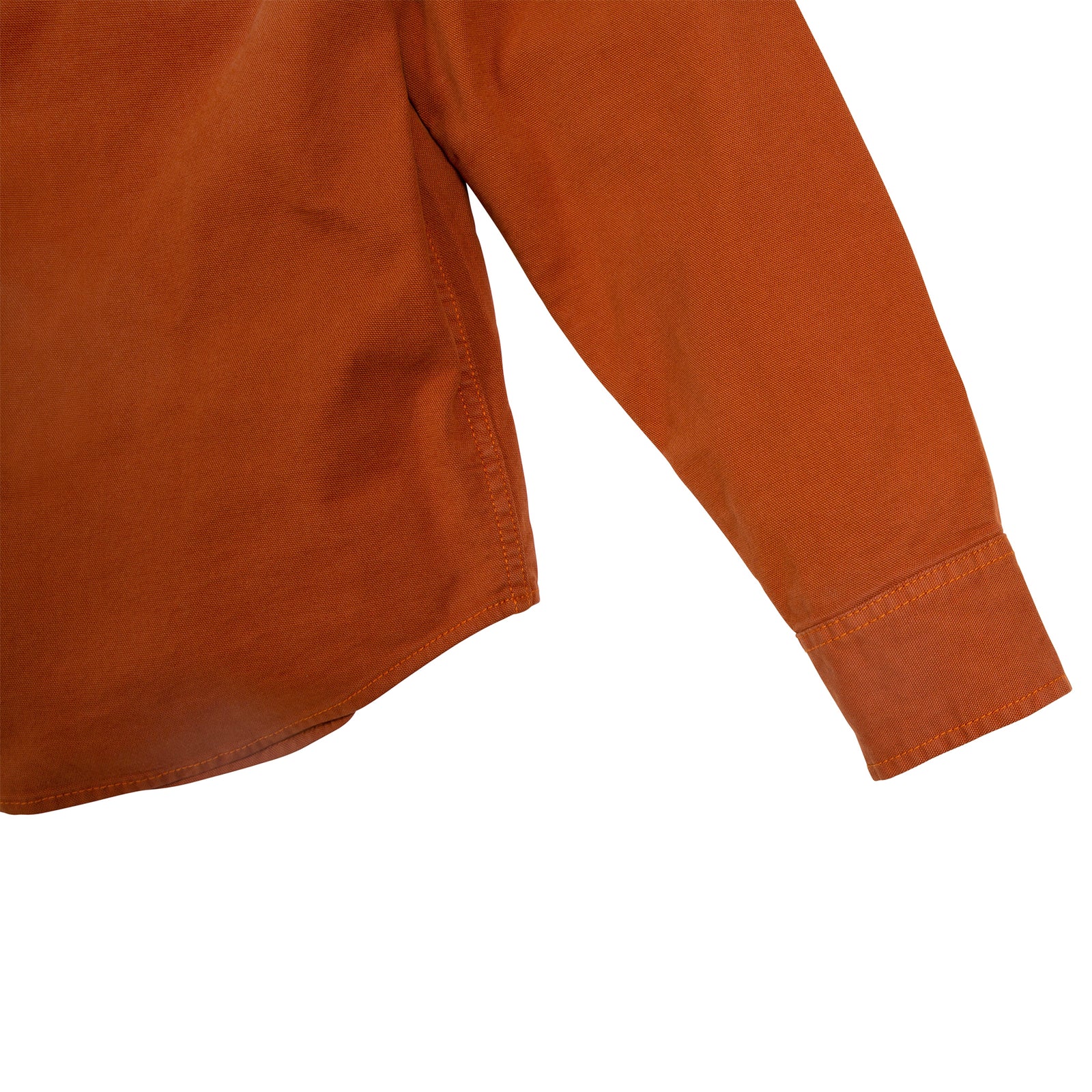 General detail shot of Topo Designs Women's Dirt Shirt in Brick orange showing sleeve cuff.