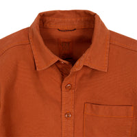 General detail shot of Topo Designs Men's Dirt Shirt in Brick orange showing collar, buttons, and chest pocket.