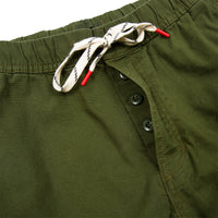 General detail shot of Topo Designs Men's Dirt Pants in Olive green showing button fly and drawstring waistband.