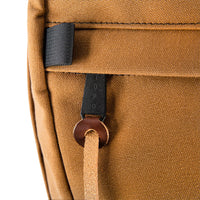 General detail shot of Topo Designs Daypack Heritage Canvas in Dark Khaki Canvas/Dark Brown Leather showing custom zipper pull hardware.