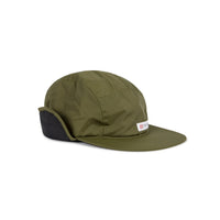 Topo Designs Puffer Cap insulated hat with ear flaps in "Olive / Black" green.