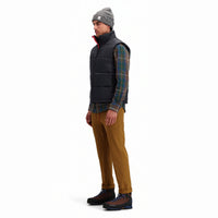 Side model shot of Topo Designs Men's Mountain Puffer recycled insulated Vest in "Black".