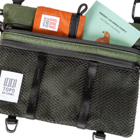 General shot of Topo Designs Mountain Accessory crossbody Shoulder Bag in olive green showing map and micro accessory bag inside.