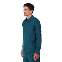 Topo Designs Men's Dirt Shirt long sleeve organic cotton button-up in "pond blue" on model side.