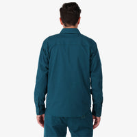 Topo Designs Men's Dirt Shirt long sleeve organic cotton button-up in "pond blue" on model back.