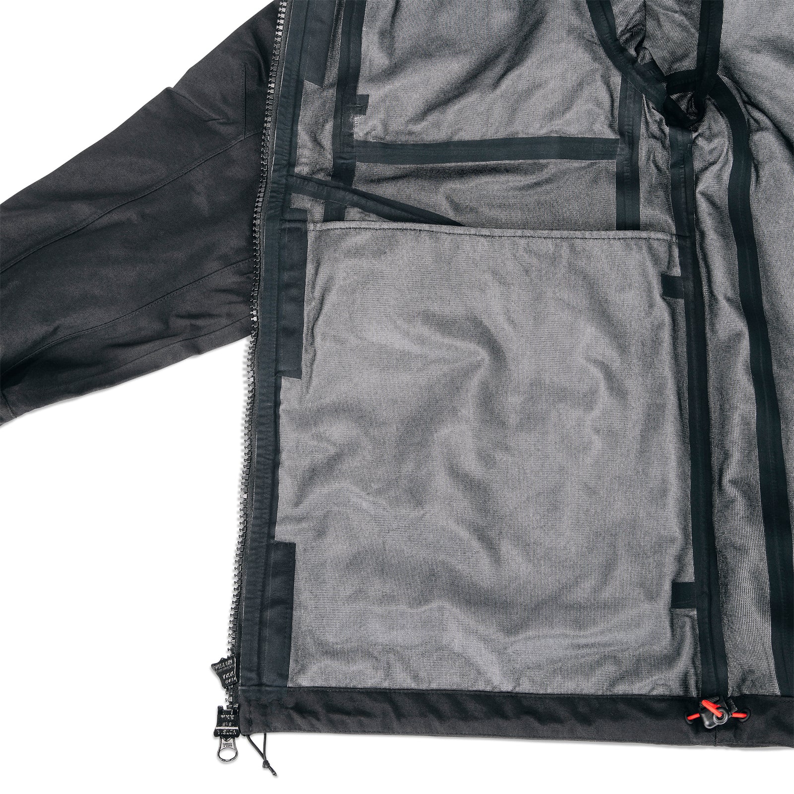 General shot of internal seam taping on Topo Designs Men's Mountain Parka waterproof shell jacket in black.