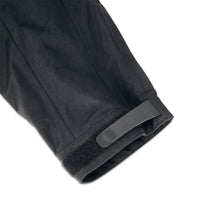 General shot of velcro cuff adjustments on Topo Designs Men's Mountain Parka waterproof shell jacket in black.