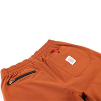 General shot of Topo Designs women's boulder pants in brick orange detail of back pockets.