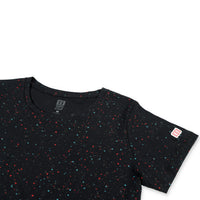 General detail shot of Topo Designs Women's Cosmos short sleeve organic cotton t-shirt in black showing collar and logo map patch on sleeve.