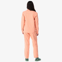  Topo Designs Women's Dirt Shirt long sleeve stretch cotton button-up in peach "pink" on model back.