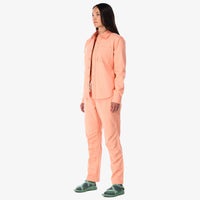  Topo Designs Women's Dirt Shirt long sleeve stretch cotton button-up in "peach" pink on model side.