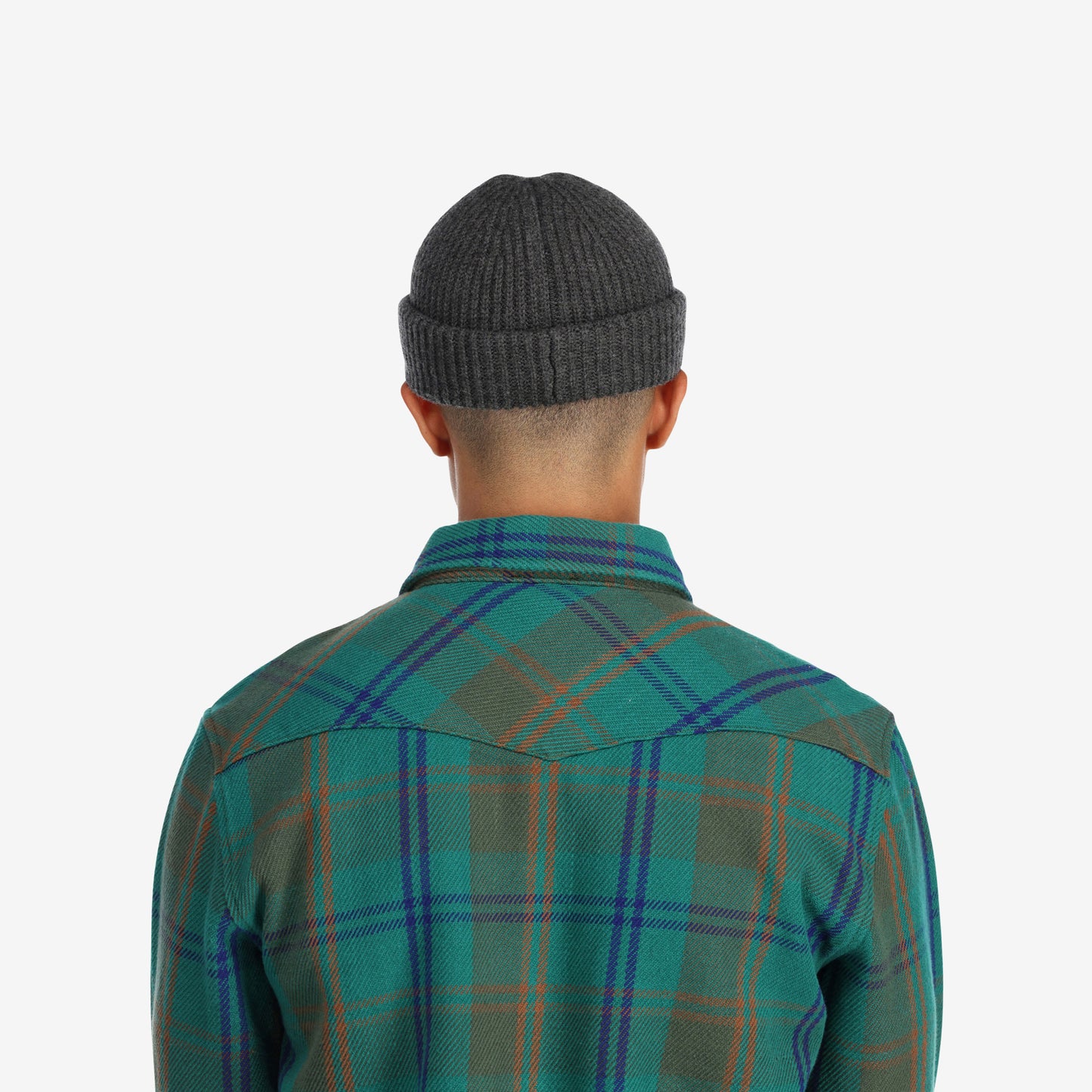 Back model shot of Topo Designs Global Beanie merino wool blend watchman cap in "charcoal" gray