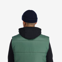Back model shot of Topo Designs Global Beanie merino wool blend watchman cap in "navy" blue