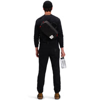 Back model shot of Topo Designs Men's Dirt Crew sweatshirt in 100% organic cotton in "black"