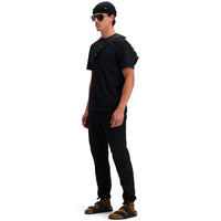 Side model shot of Topo Designs Men's Dirt Pocket Tee 100% organic cotton short sleeve t-shirt in "black". Show on "pond blue"