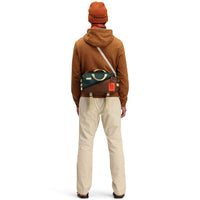 Back model shot of Topo Designs Men's Dirt Hoodie 100% organic cotton French terry sweatshirt in "earth" brown