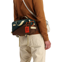 Back model shot of Topo Designs Men's Dirt Crew sweatshirt in 100% organic cotton in "earth" brown