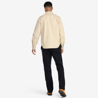 Back model shot of Topo Designs Men's Dirt Shirt long sleeve organic cotton button-up in "sand".