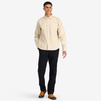 Front model shot of Topo Designs Men's Dirt Shirt long sleeve organic cotton button-up in "sand".