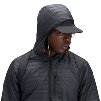 General shot of hood detail on model wearing Topo Designs Men's Global Puffer packable recycled insulated Hoodie jacket in "black"