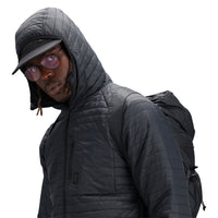 General shot of hood detail on model wearing Topo Designs Men's Global Puffer packable recycled insulated Hoodie jacket in "black"