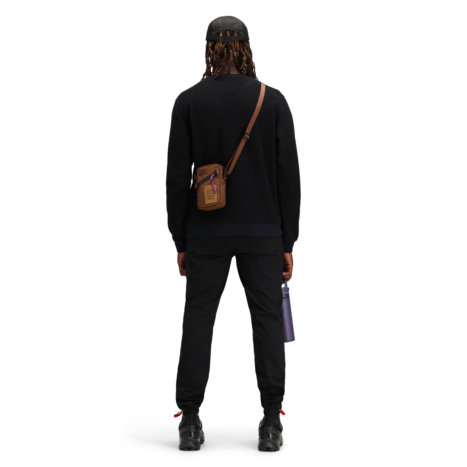 General back model shot of Topo Designs Mini Shoulder Bag crossbody travel purse in "Cocoa" brown recycled nylon.