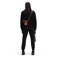 Back of model wearing Topo Designs Men's Global pullover Sweater recycled washable Italian wool in "black". Show on "navy"