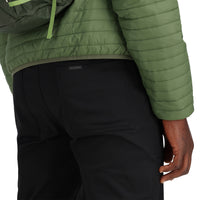 General detail shot of bottom hem on model wearing Topo Designs Men's Global Puffer packable recycled insulated Hoodie jacket in "olive" green.