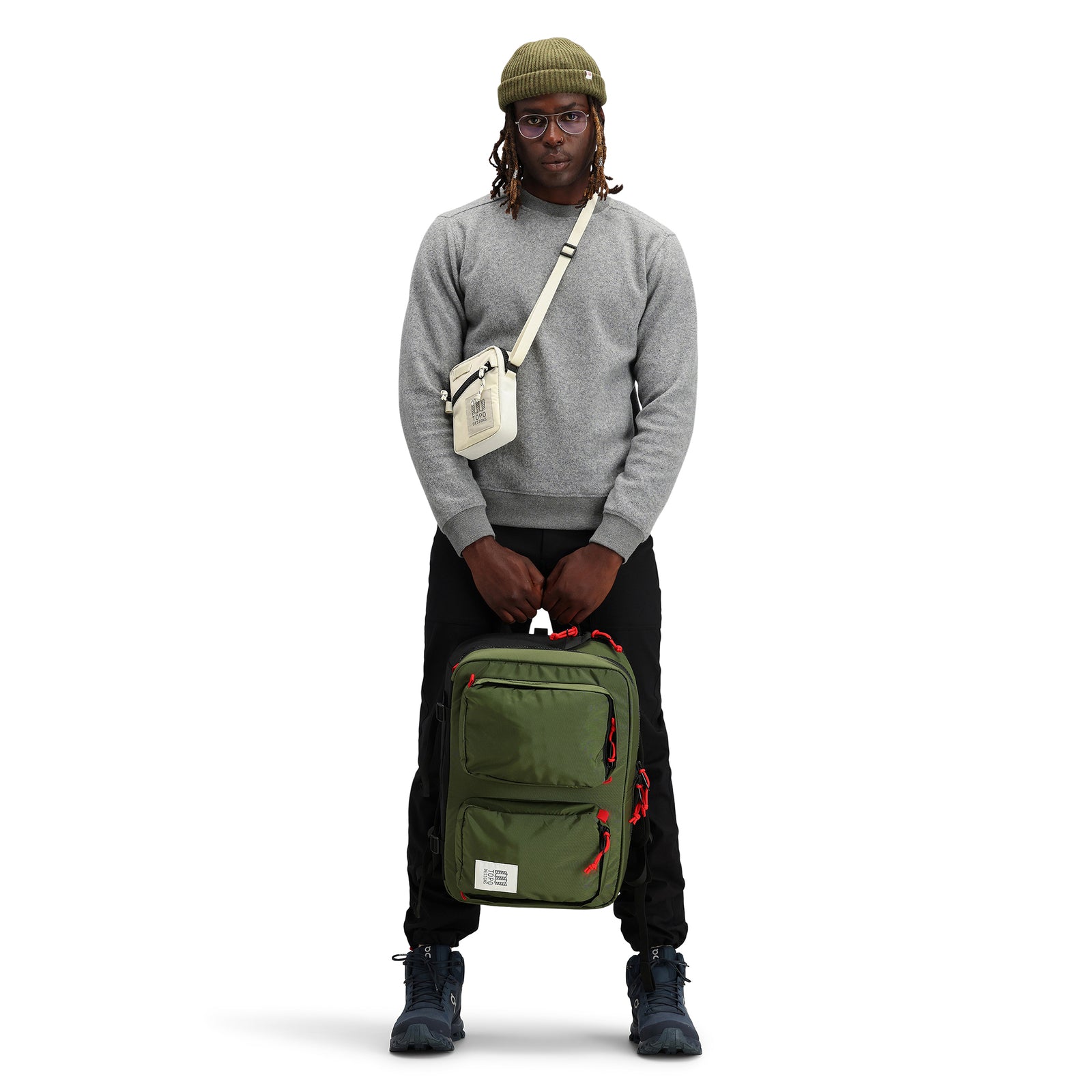 General front model shot of Topo Designs Global Briefcase convertible laptop travel backpack in "Olive" green nylon.
