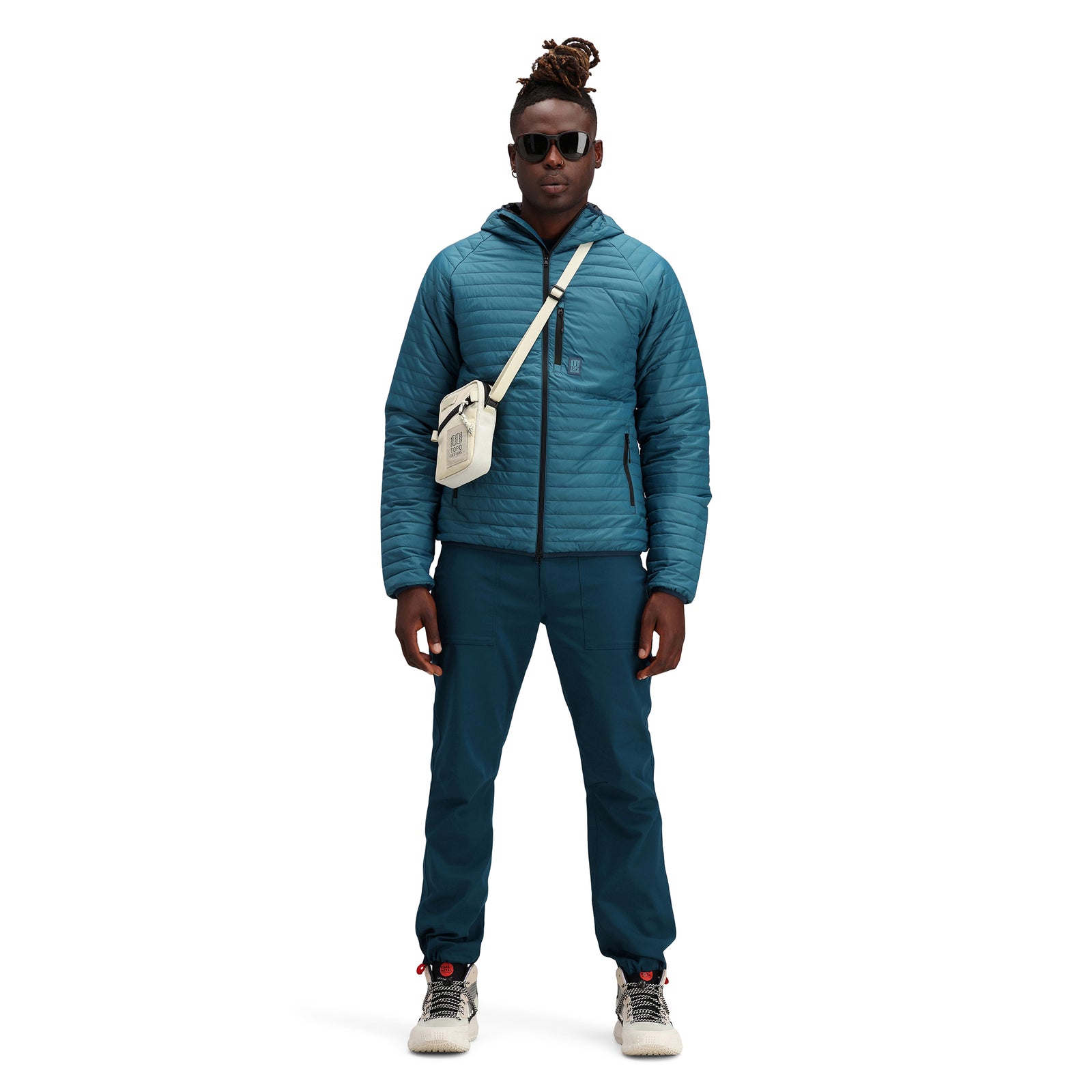 Front model shot of Topo Designs Men's Global Puffer packable recycled insulated Hoodie jacket in "pond blue". 