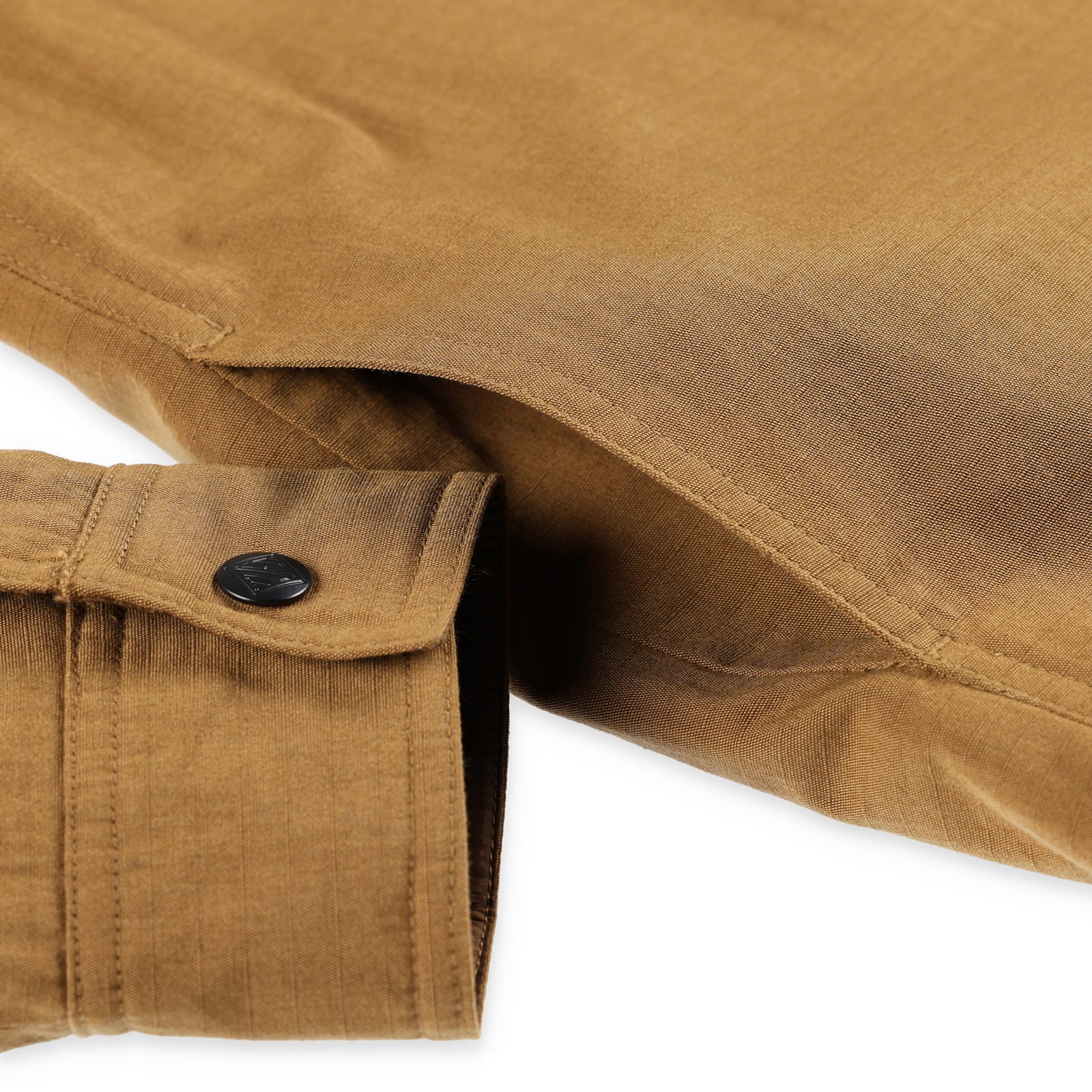 General detail shot of side hand pockets on Topo Designs Men's Insulated Reversible Shirt Jacket in "dark khaki" brown