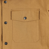 General detail shot of snap chest pocket on Topo Designs Men's Insulated Reversible Shirt Jacket in "dark khaki" brown